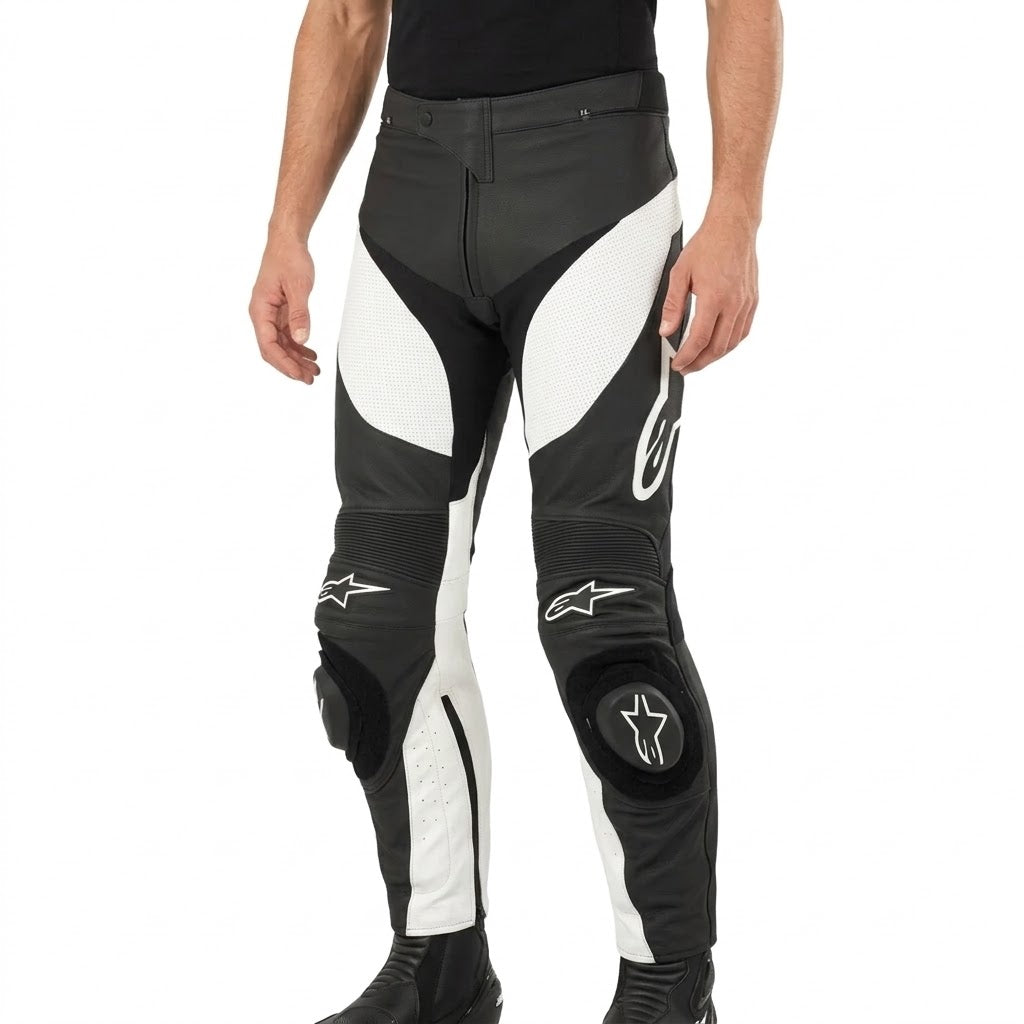 Black and white Alpinestars motorcycle leather pants with knee protection, shown on a model from the waist down against a white background.