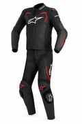 Black and charcoal one-piece motorcycle racing suit with red accents, white chest graphic, and contrasting knee details on a clean white background